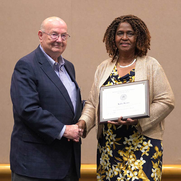 Kathy Brown receiving her award from Chancellor Jimmy Baker