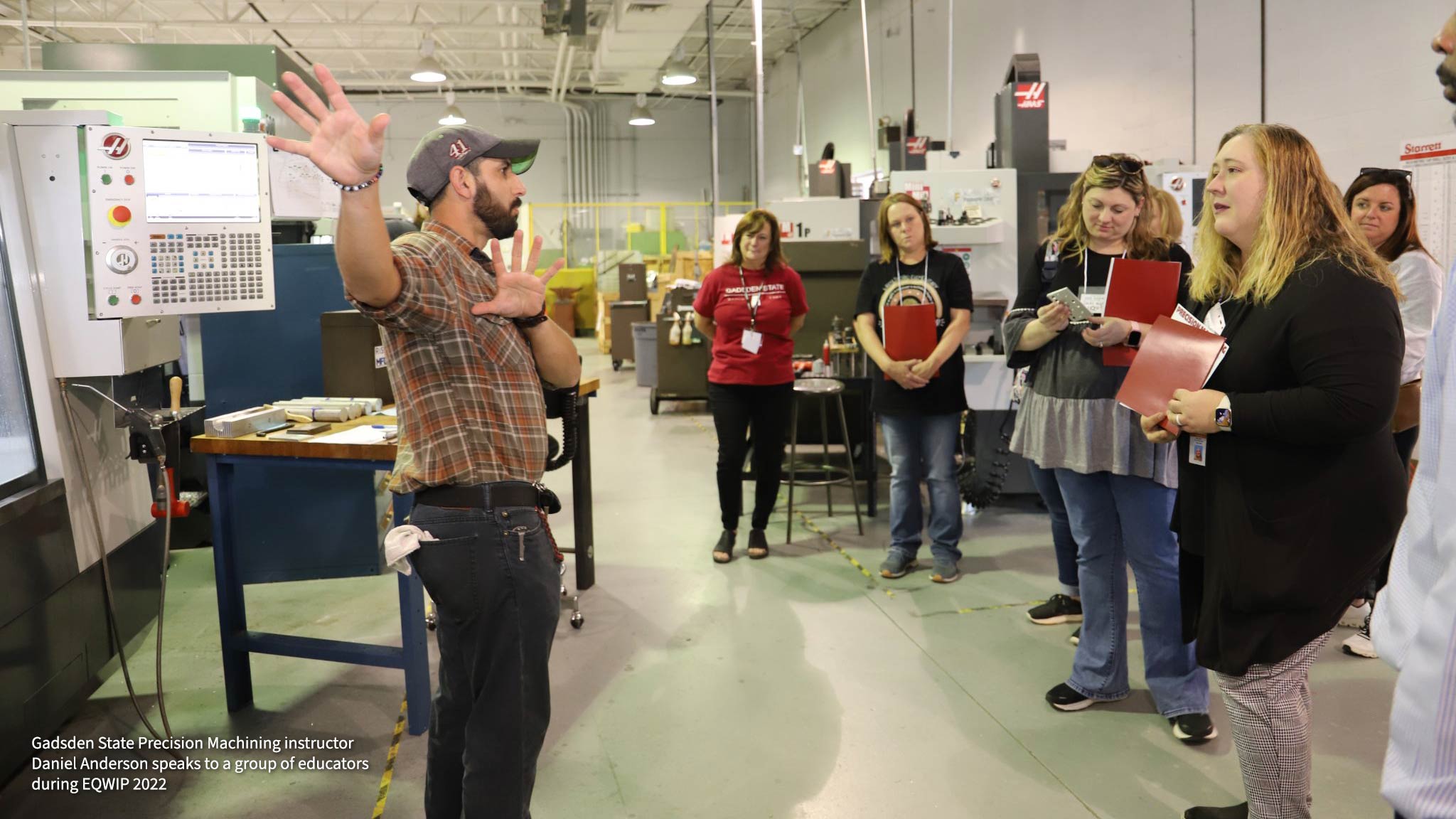 Gadsden State Precision Machining instructor Daniel Anderson speaks to a group of educators during EQWIP 2022