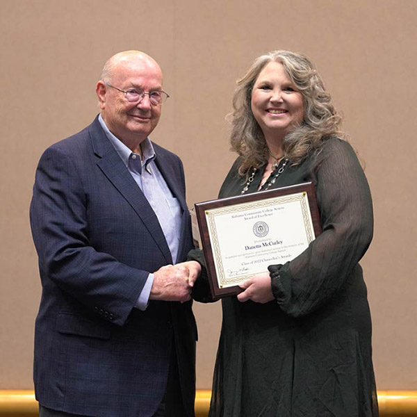 Danetta McCurley receiving her award from Chancellor Jimmy Baker