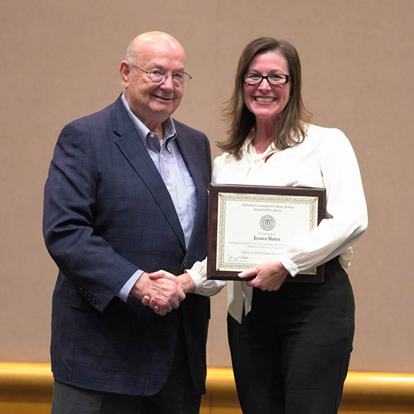 Jessica Slaten receiving her award from Chancellor Jimmy Baker