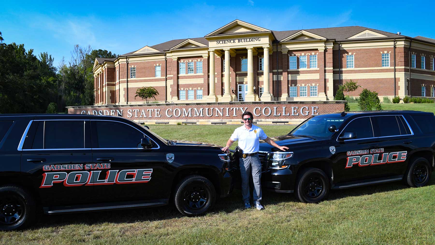 Police Chief Jay Freeman and the GSCC police vehicles in front of the Science Building