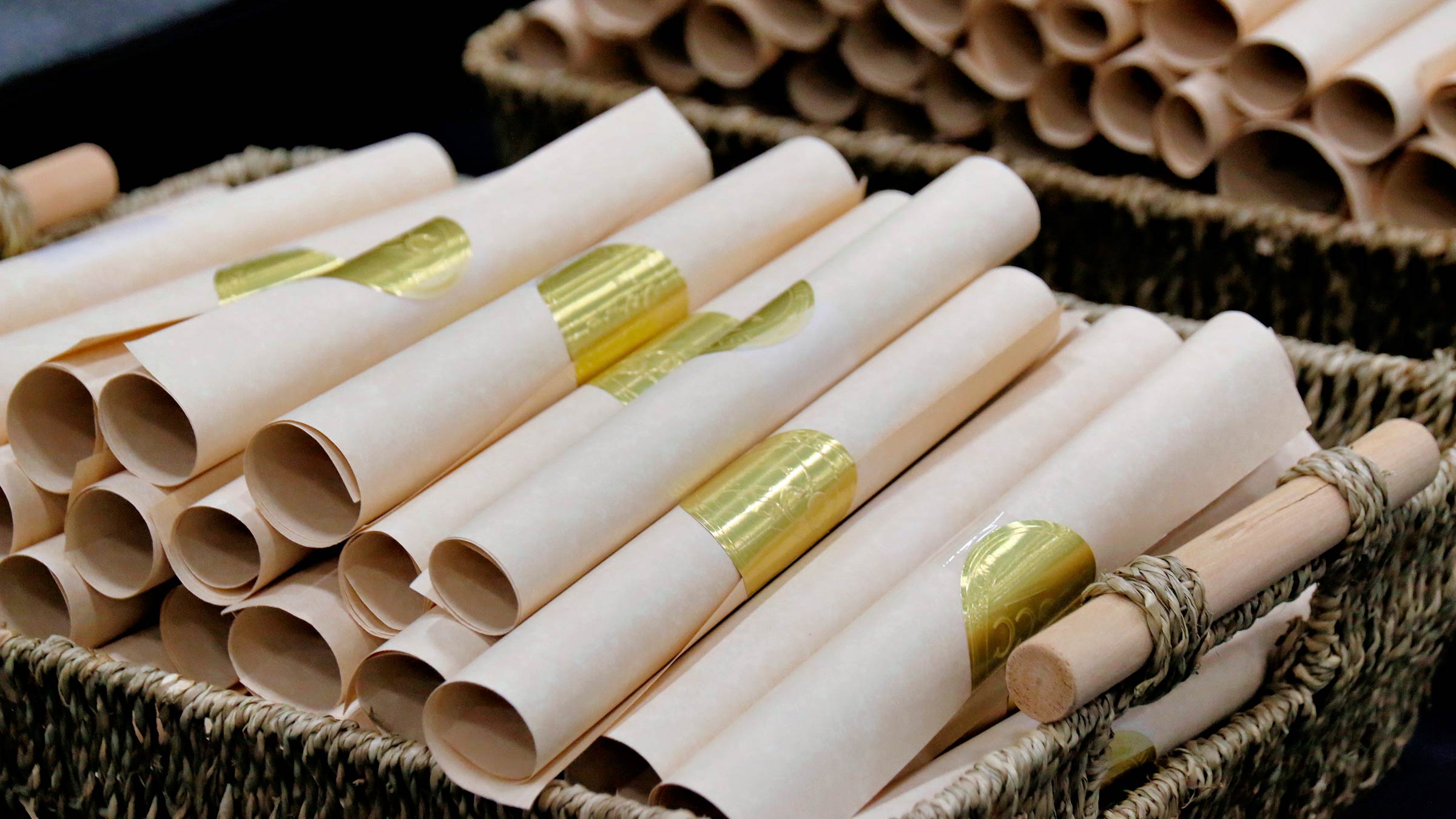 A basket of rolled certificates at commencement