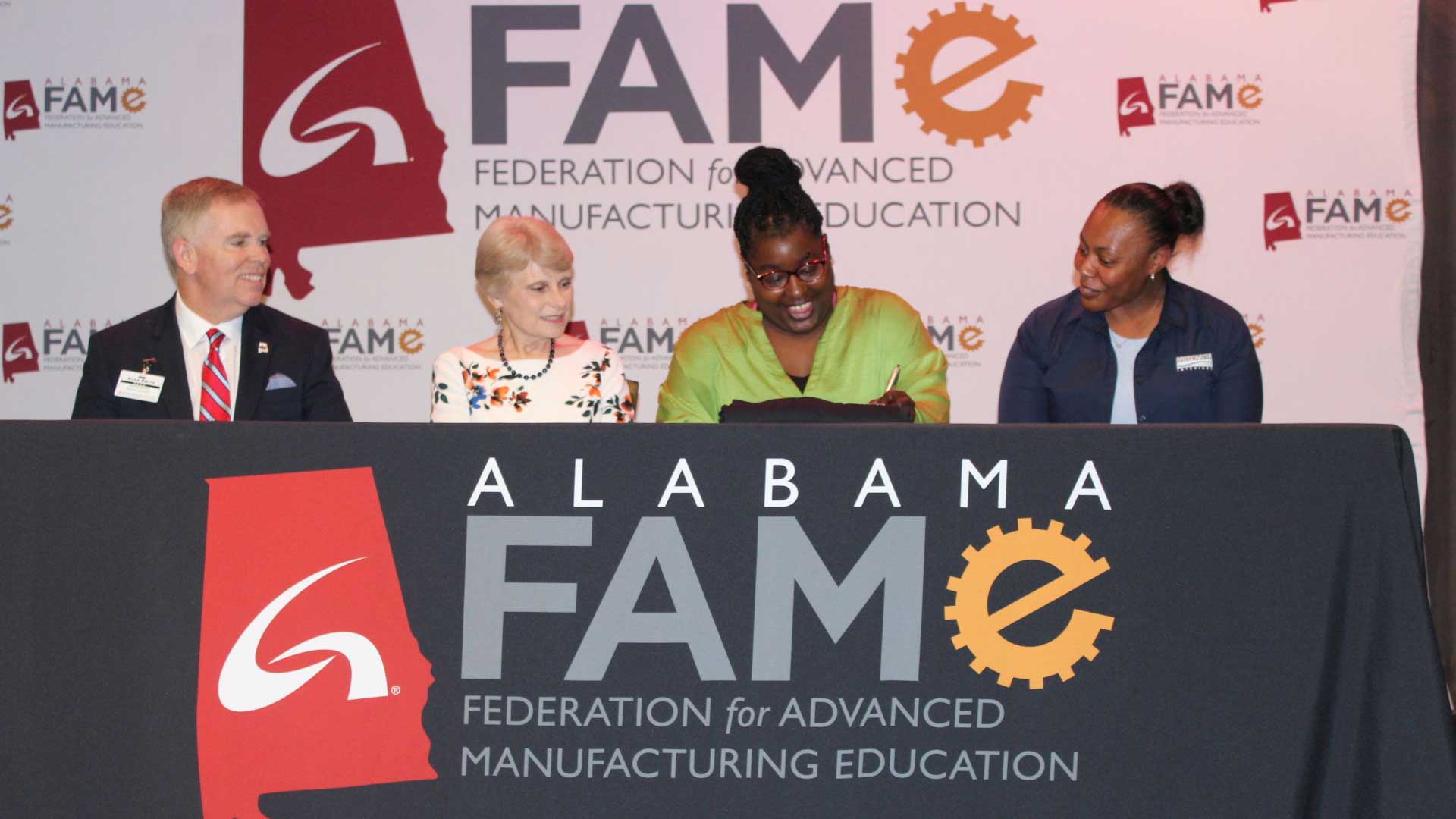 Taleasha Smoot signs her FAME pledge and commitment to Bridgewater Interiors at the FAME Signing Day held May 18 at the Oxford Civic Center. She is pictured with, from left, Alan Smith, dean of Workforce Development; Dr. Kathy Murphy, president of Gadsden State; and April Stillwell, training and development coordinator at Bridgewater Interiors.